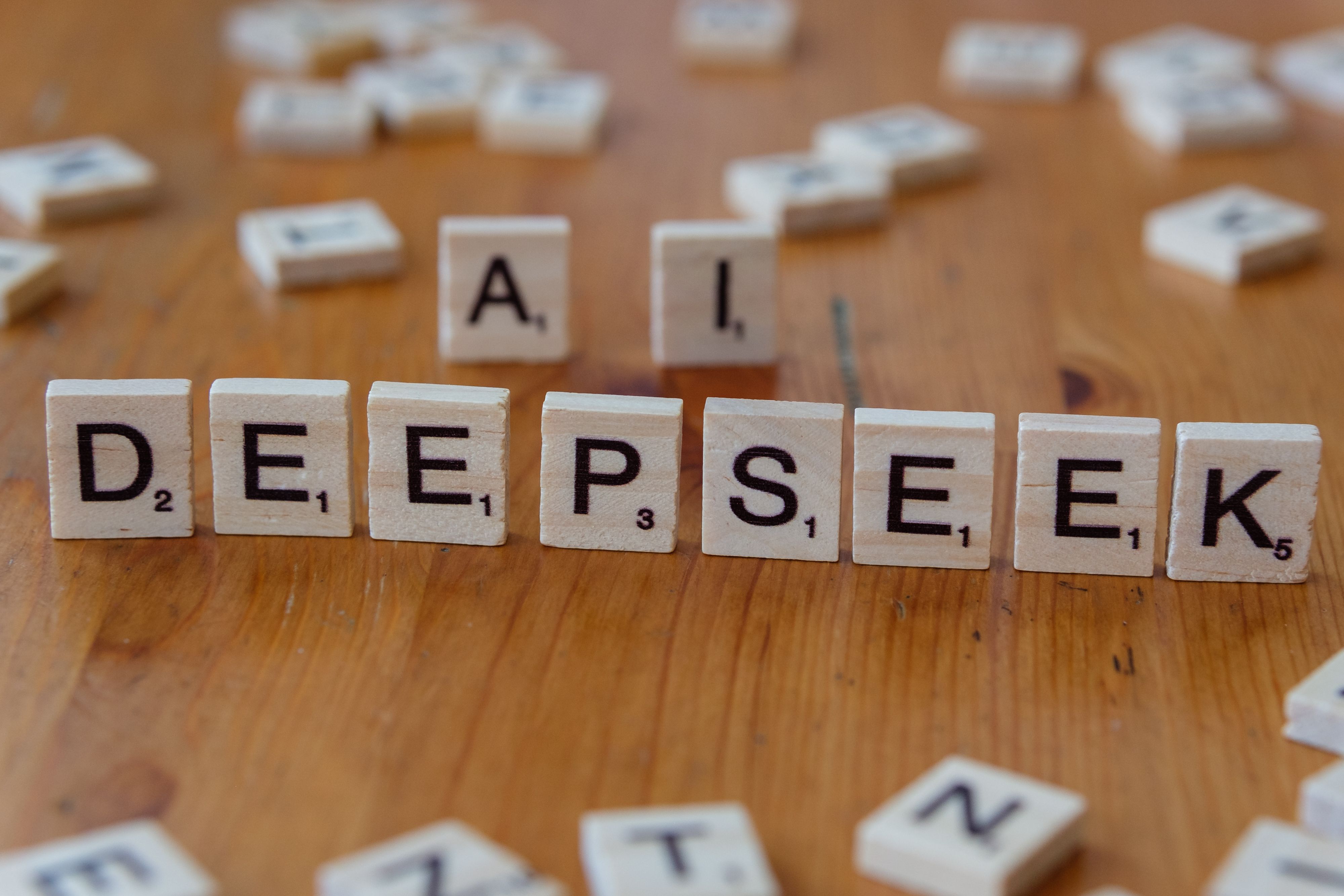 Scrabble tiles spelling DeepSeek — AI concept